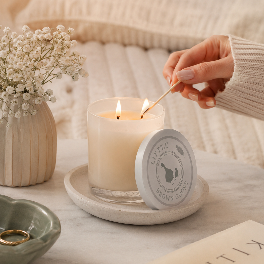 Large double-wicked soy wax candle glowing in a cosy Australian living room