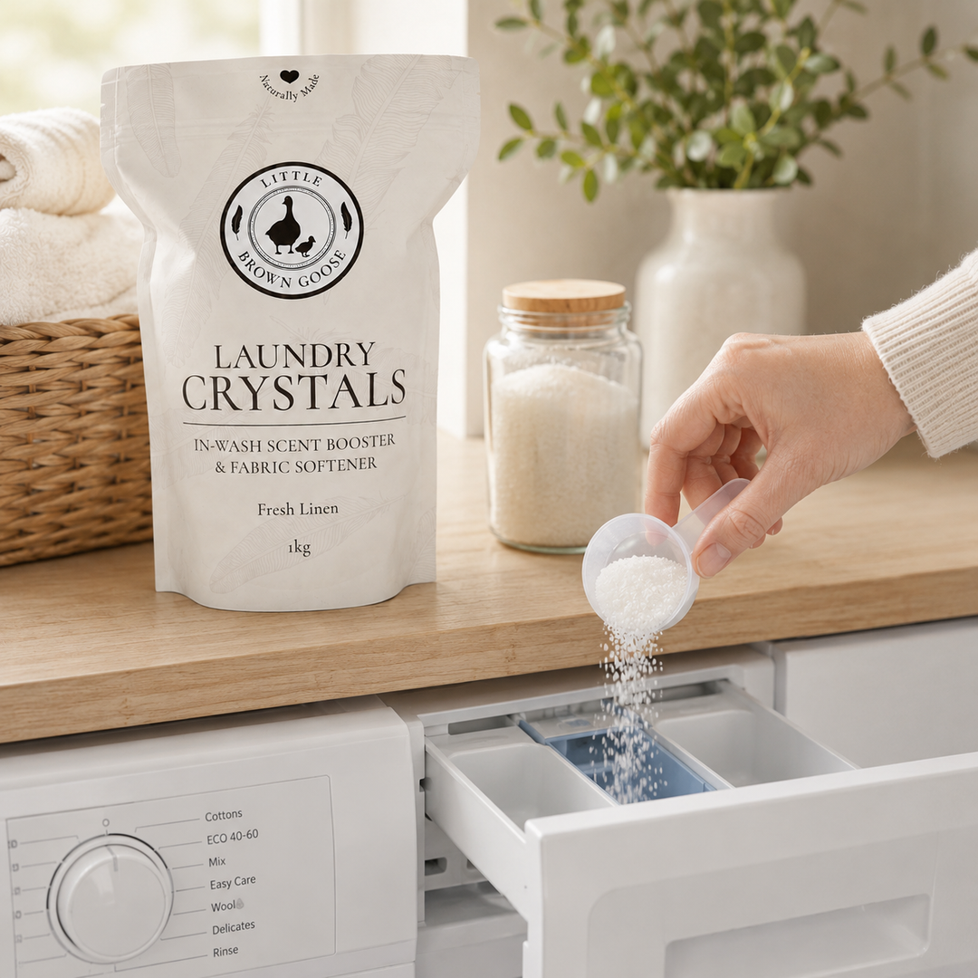 One tablespoon of laundry crystals being added to a front-loading washing machine
