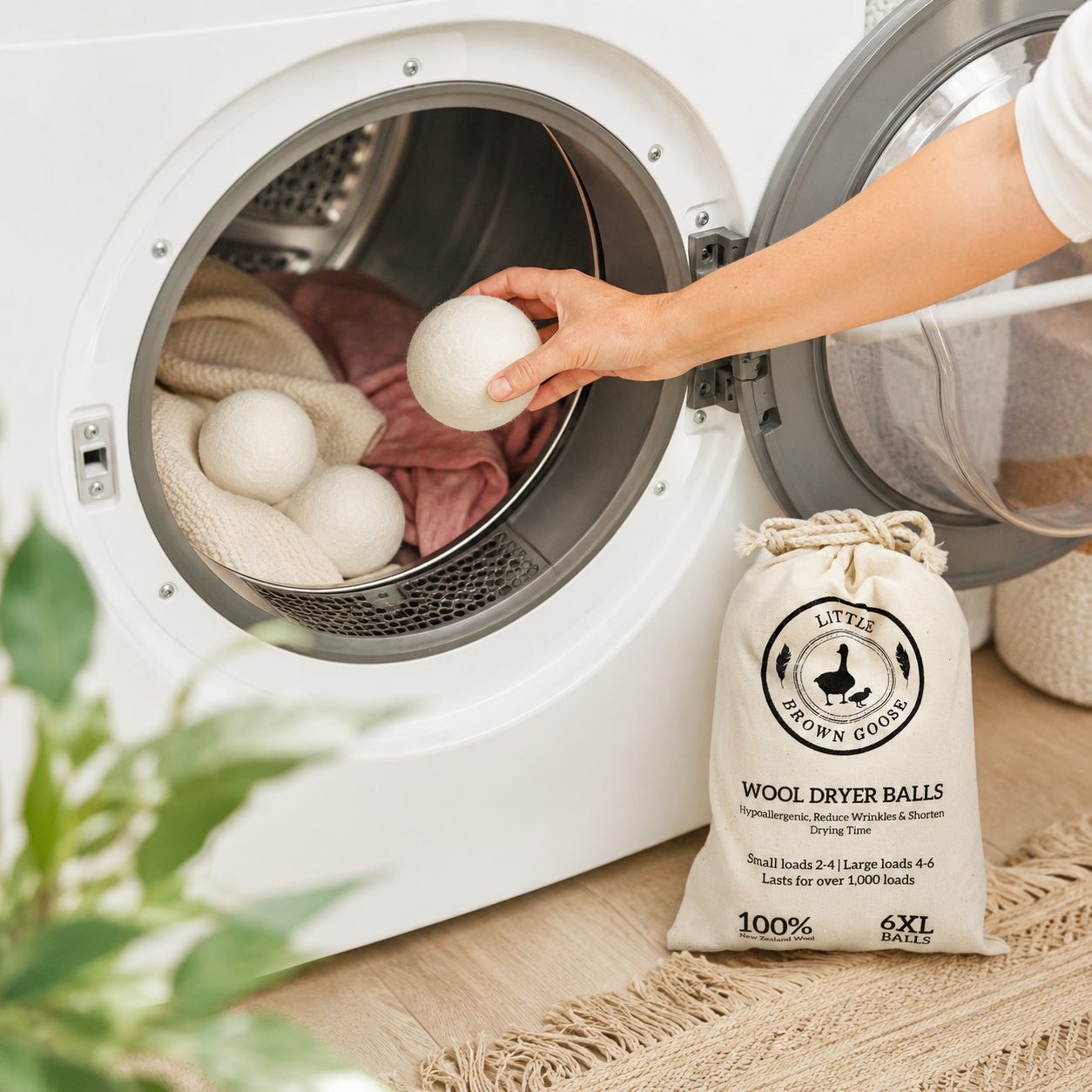 Six reusable wool dryer balls beside fresh towels and Little Brown Goose laundry products