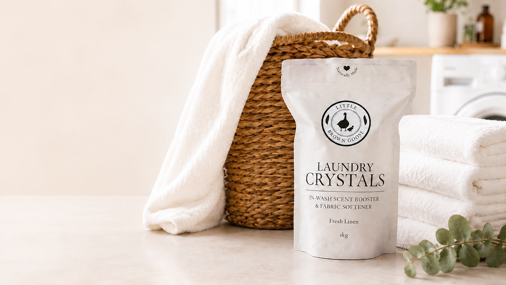 Little Brown Goose Laundry Crystals in a bright laundry setting with fresh towels