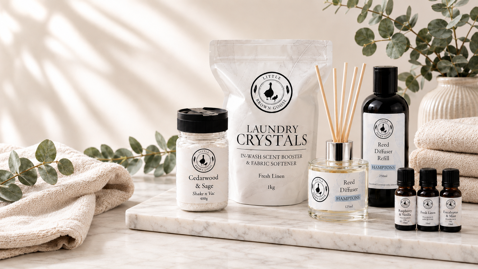 Little Brown Goose low-tox home essentials including Laundry Crystals, Shake n Vac, reed diffuser and fragrance oils